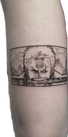 a man's leg with a black and white drawing of an anime character on it