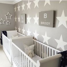 a baby's room with stars painted on the wall and crib bedding