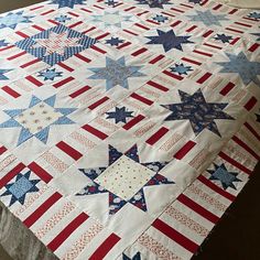 an american flag quilt on top of a bed