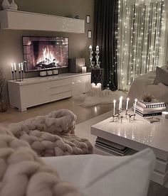 a living room filled with furniture and a flat screen tv on top of a wall