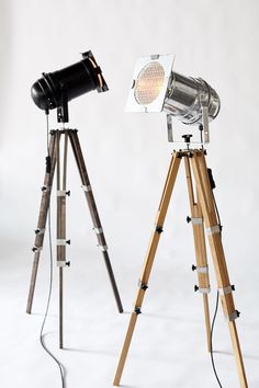 two wooden tripod lights with one light on top and the other turned on to look like an old movie camera