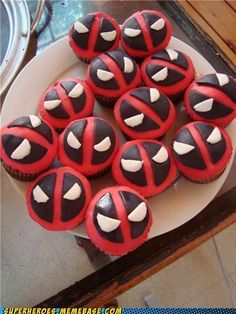 cupcakes decorated with red and black frosting on a plate