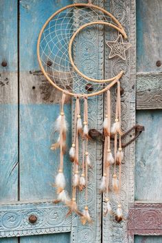 a dream catcher hanging on the side of a wooden door