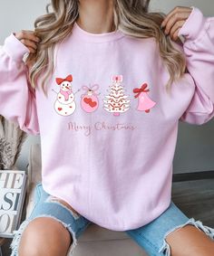 Cute Christmas Sweater in Pink; Coquette vibes ♥PRODUCTION TIME: 1-5 days (Usually 2-3 days) ♥SHIPPING TIME: 2-5 days (Usually 3 days) ♥PRODUCT DESCRIPTION: Gildan 18000 Crewneck Sweatshirt Super soft cotton and excellent quality print makes. 50% US 100% cotton 8.0 oz/yd² Runs true to size Our relaxed fit sweatshirt is a unisex style that runs a touch small for men, and about half a size large for women. It has a relaxed fit and is soft and cozy. * For Sweatshirt Sizes Please refer to the Listin Pink Christmas Sweater, Coquette Vibes, Snowman Sweater, Cute Christmas Sweater, Coquette Christmas, Bow Christmas, Christmas Crewneck, Pink Coquette, Sweater Christmas