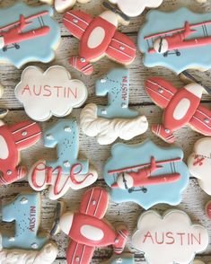 decorated cookies with the words, one, and an airplane on them are laid out next to each other