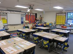 an empty classroom with desks and chairs