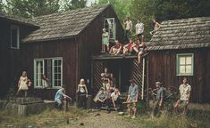 a group of people sitting on top of wooden buildings