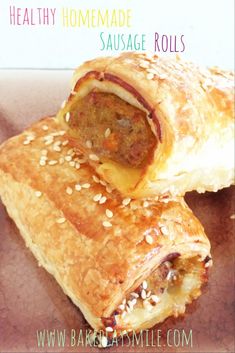 two sausage rolls on top of each other with sesame seeds and cheese in the middle