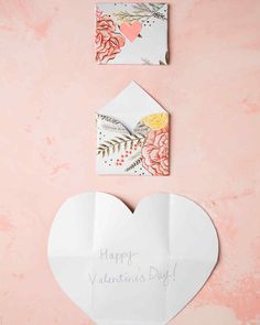 valentine's day card and envelope with flowers on pink background, top view from above