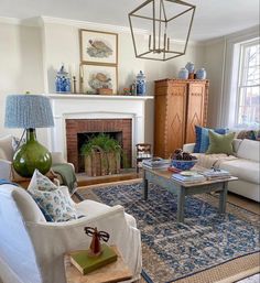 a living room filled with furniture and a fire place in the middle of a room