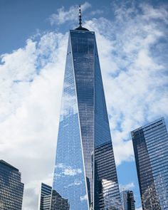 the one world trade center in new york city, with skyscrapers on either side