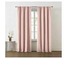 a pink curtain hanging on the side of a window next to a vase with flowers