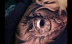 an eye tattoo on the leg of a person