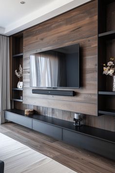 the entertainment center is built into the wall with wooden paneling and glass doors on each side