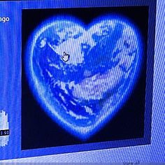 a heart - shaped earth is shown on a monitor screen