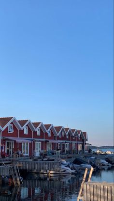 a row of red houses sitting on top of a pier