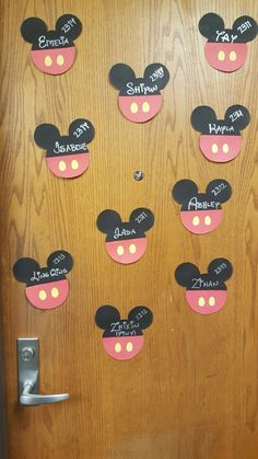 a door decorated with mickey mouse ears and name tags for each child's name