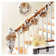 a staircase decorated for christmas with wreaths and decorations