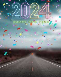 a road with confetti and the words happy new year on it