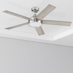 a ceiling fan in a room with white walls