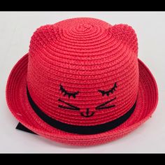 a red hat with a cat face drawn on it