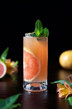 a grapefruit cocktail garnished with mint