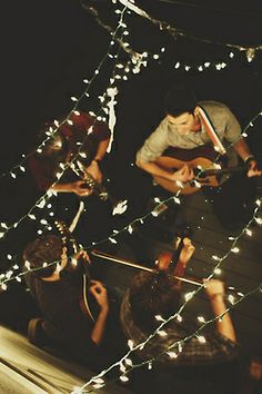 a group of people standing around each other with lights on them and the words music tips above them