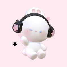 a white stuffed animal with headphones on