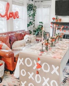 Table is in a living room with fun Valentine's Day decor all over Valentine Dinner Party, Valentines Home Decor, Galentines Brunch, Valentines Brunch, Galentines Day Ideas, Valentines Party Decor, Galentines Party, Valentine Dinner, Valentine Party