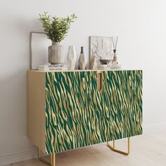 a sideboard with zebra print on it and vases sitting on top of it