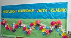 a bulletin board with flowers on it in front of a wall that reads middle school lessons with reading