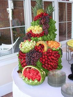 a table topped with lots of different types of fruits and veggies on top of it