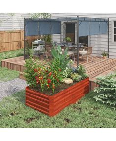 a wooden deck with plants and flowers in the garden next to a building that has an awning over it