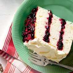 a piece of cake sitting on top of a green plate next to a knife and fork