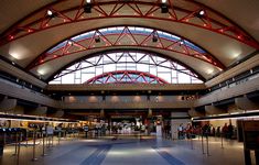 the inside of an airport with people walking around