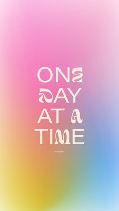 the words one day at a time are in white on a multicolored background