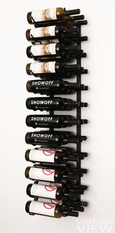 a wall mounted wine rack filled with lots of bottles on top of eachother