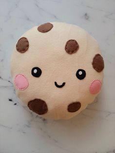 a close up of a doughnut on a marble surface with brown and pink dots