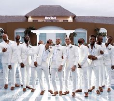 a group of men in white suits standing next to each other