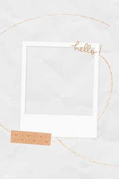 a white photo frame sitting on top of a piece of paper with the word hello written above it