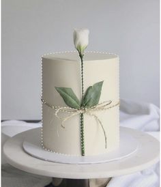 there is a white cake with a flower on it