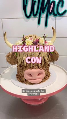 there is a cake that looks like a cow with flowers on it's head