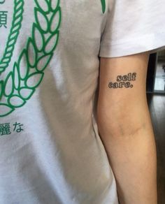 a man with a tattoo on his arm that reads, hello coffee in chinese characters