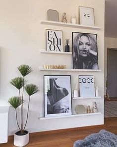 a living room filled with furniture and pictures on the wall