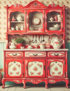 a red china cabinet with dishes on it