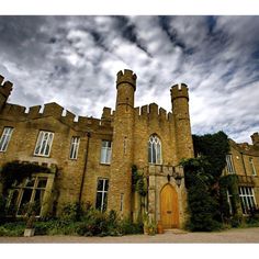 an old brick castle with ivy growing on it's walls and door in front