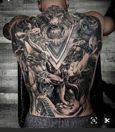 the back of a man with tattoos on his upper and lower half, including an image of