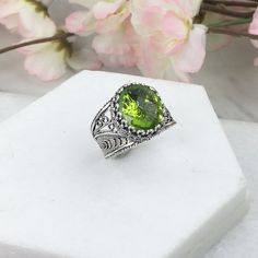 925 Sterling Silver Oval Filigree Ring with Peridot Doublet Quartz Natural Gemstone  Material: 925 Solid Sterling Silver, Peridot Gemstone Gemstone Dimensions: 12 mm x 10 mm, Oval, Faceted Ring Face Length: 0.60 inch   Ring Face width: 0.50 inch This will come in a designer pouch & gift box  Free Domestic Shipping  It is a gift that will create memories for years to come. Our fine silver jewelry is Made in our exclusive Artisan workshops in Turkey. Our aim is to exceed all the expectations that Green Oval Engraved Rings, Handmade Oval Peridot Rings, Green Oval Filigree Ring In Sterling Silver, Green Filigree Ring As Fine Jewelry Gift, Green Filigree Ring Fine Jewelry For Gift, Silver Leaf Art, Faceted Ring, Fine Silver Jewelry, Gold Filled Ring