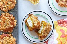 some muffins are sitting on plates next to each other