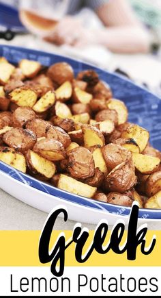 a blue plate filled with lemon potatoes on top of a white and yellow table cloth